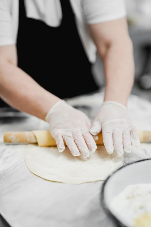 Chef hand-rolling fresh pasta dough at Monaco