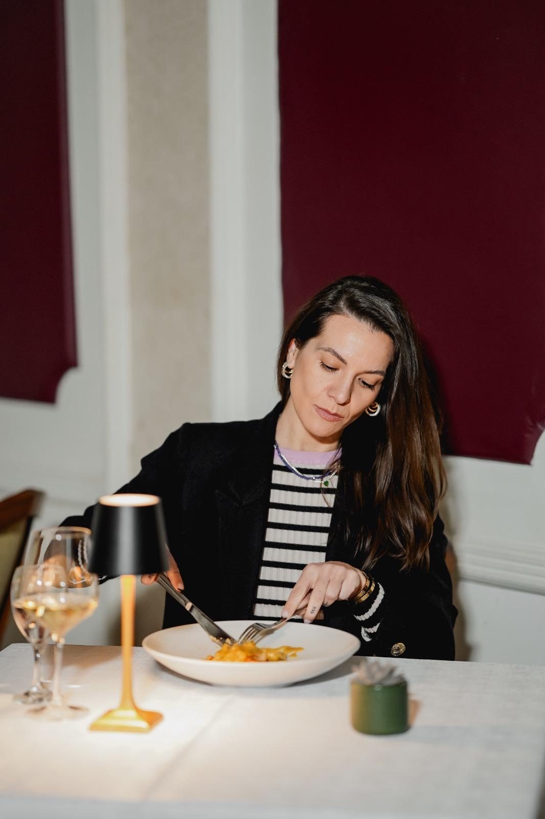 Guest dining in Monaco's warmly lit interior dining room